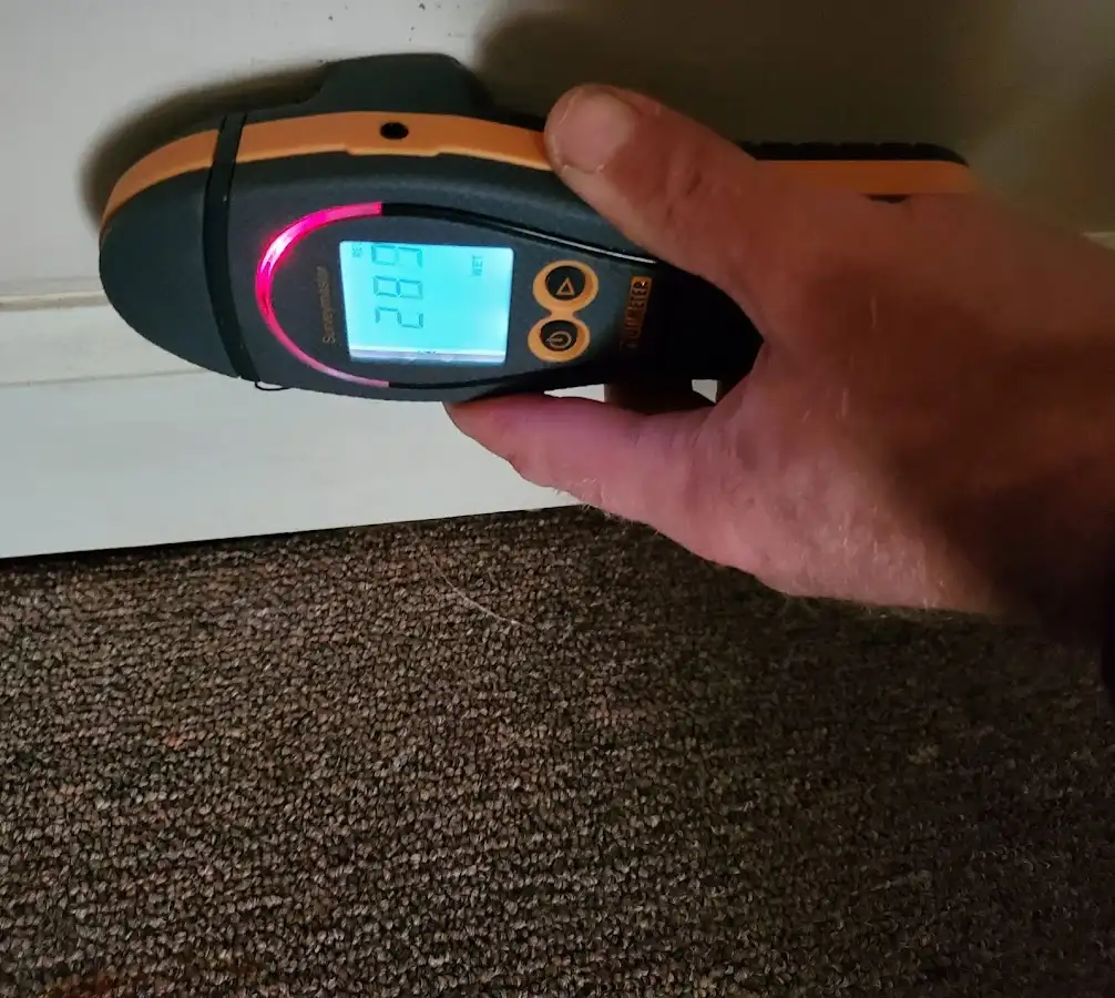 Moisture detection at baseboard during Storm Damage Restoration in Easton